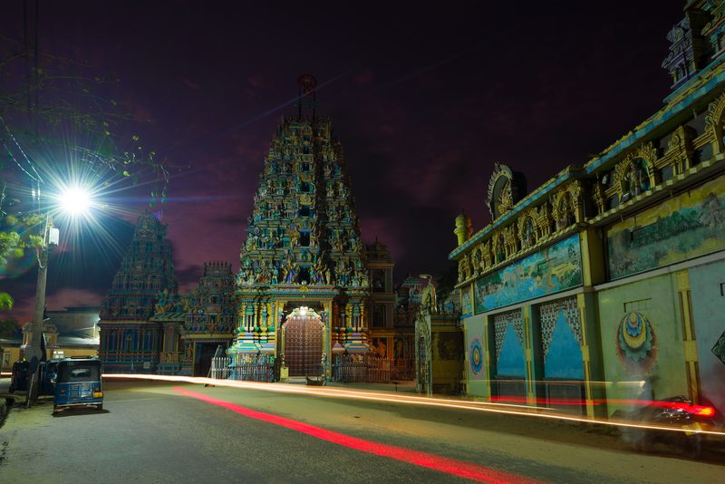 Colourfully ornamented Hindu temple gopuram at night