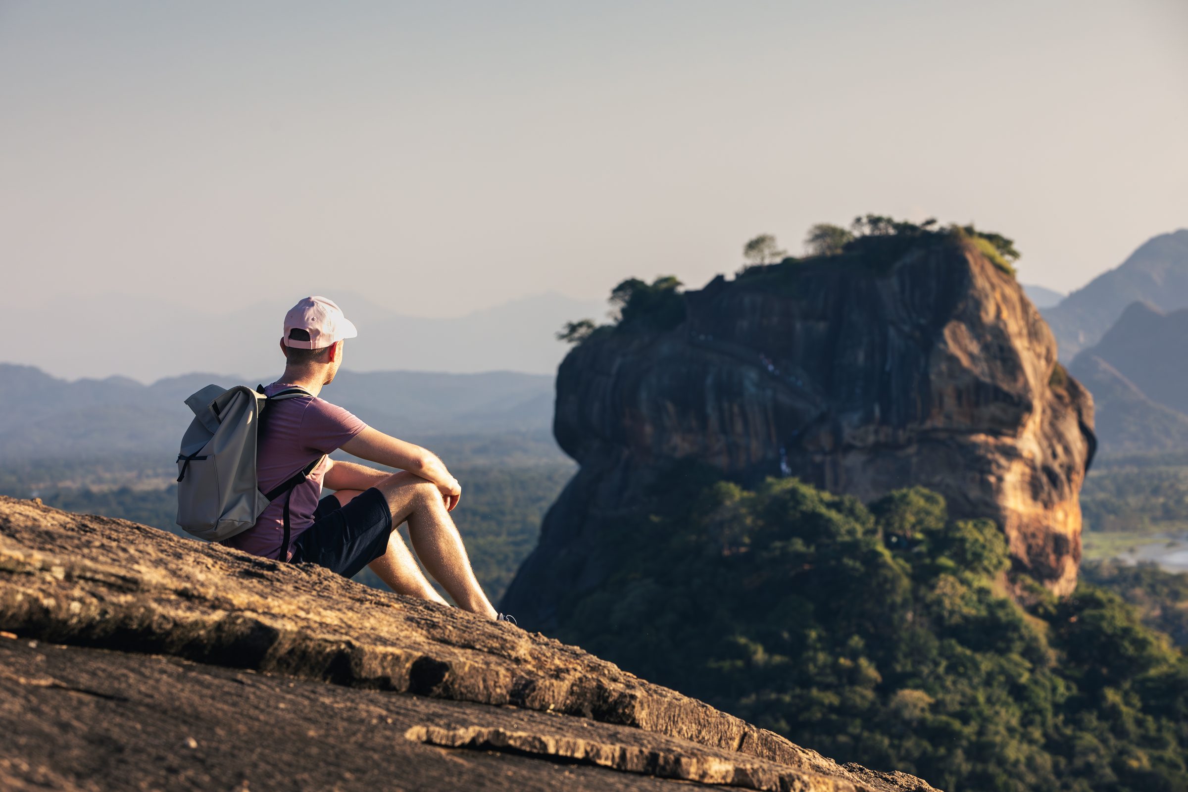 Hiker looking from Pidurangala Rock towards Sigiriya Rock