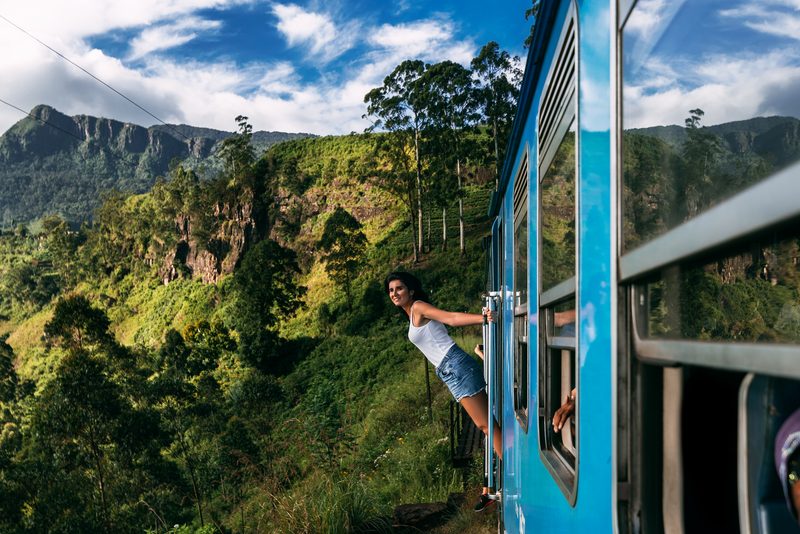 Traveller enjoying a tropical train ride through Sri Lanka
